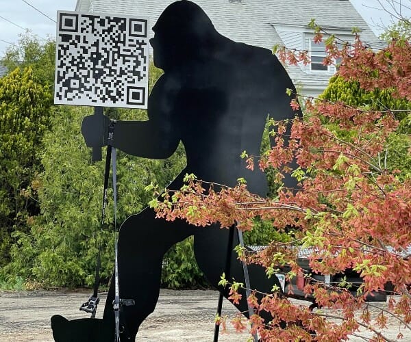 Bigfoot silhouette holding a QR Code